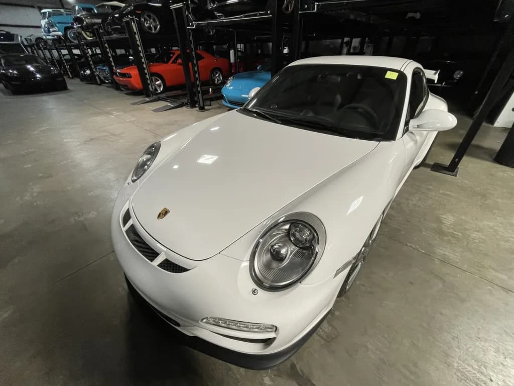 A white Porsche 911 on the A1 storage floor after its coating.